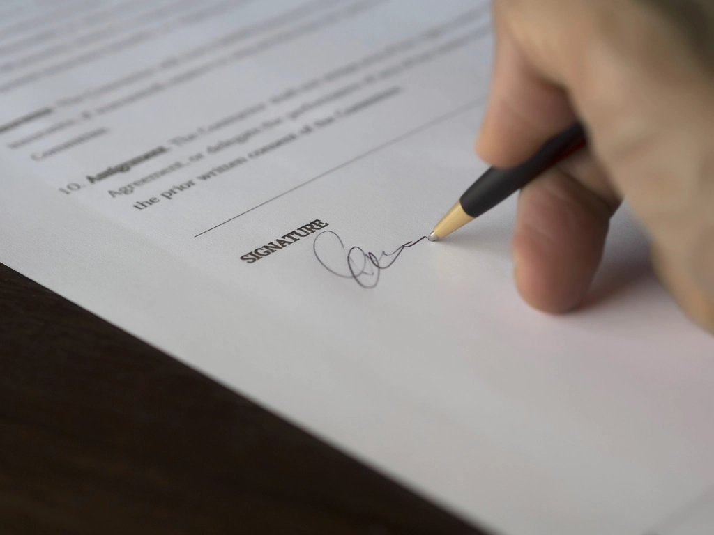 Pen resting on a signed regulatory document