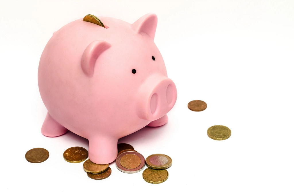 Piggy bank with coins on a table